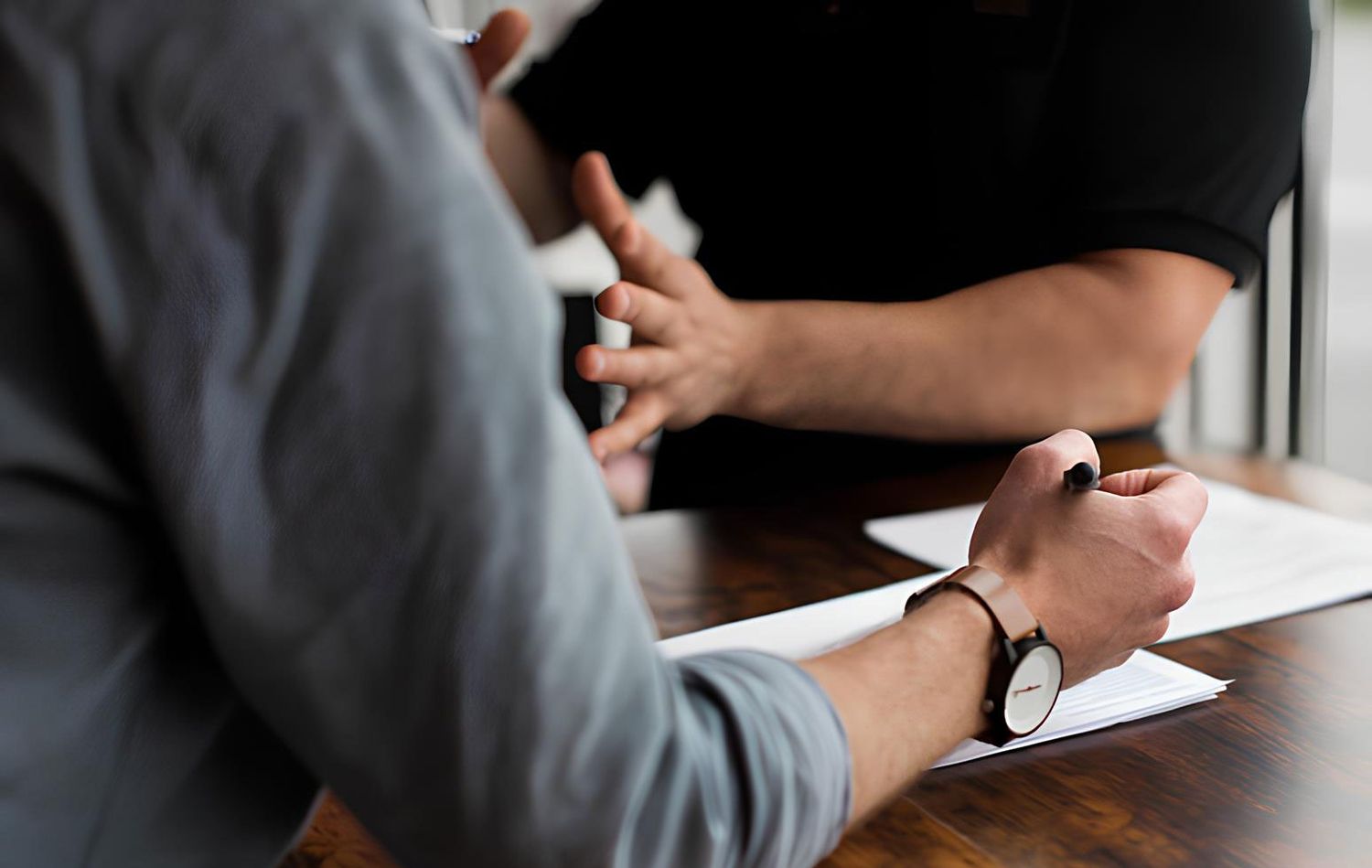 A person talks to a lawyer about his legal problems, who takes notes