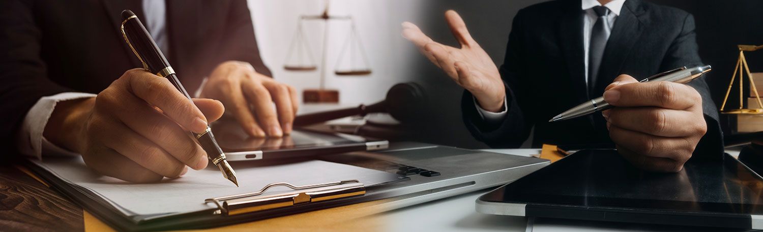 Two lawyers sit at the table and talk about documents